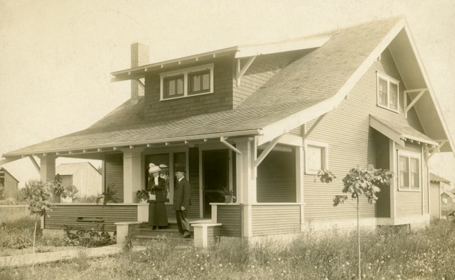 Ella and Her Husband on the Front Steps of Their New Home