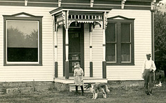 Girl, Dog, and Man in Front of a House (Cropped)
