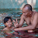 Girl taught by her father learns to swim