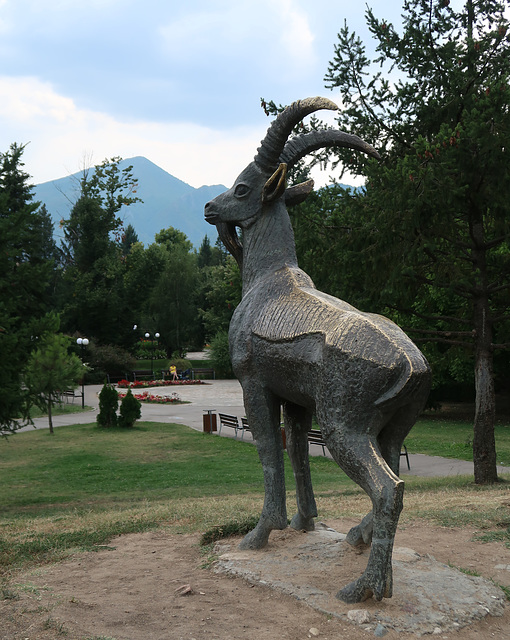Bronze billy-goat in the park