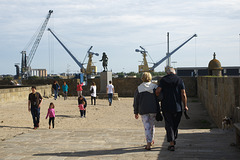 Scene with people and cranes at St Malo