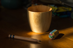 Bamboo cup, a pencil and an eraser