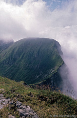 Blick vom Tomlishorn auf den Grat, der Tomlishorn und Gemsmättli sowie das Widderfeld miteinander verbindet. Beide liegen tief in der Wolken. (1980)