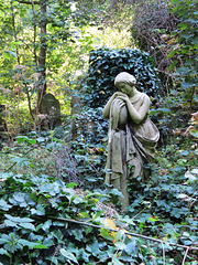 abney park cemetery, stoke newington, london,mourner on early c20 grave, the epitaph buried in undergrowth