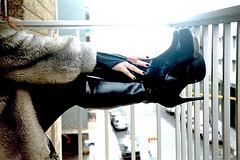 Lady Roxy /Fur and Dominatrix Boots on the balcony