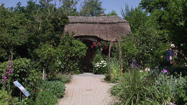 A fantastic rustic bower, with beautiful flowers adorning the walls