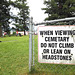What a crazy world we live in...... you have to tell people not to climb on headstones in a graveyard.