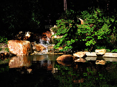 Waterfall with rocks in the Chinese garden of fragrance and splendor.