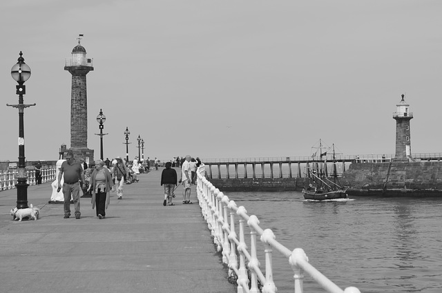 Whitby Harbour, with people strolling.