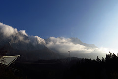 Sunset in autumn. Mount Zugspitze veiled in clouds.