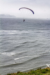 Parasailing and surfer