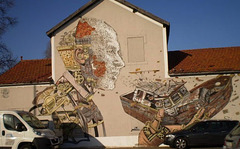 Mural by 2 street artists: Vhils (the carving) and Pixel Pancho (the painting).