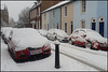 snowy cars in an English street