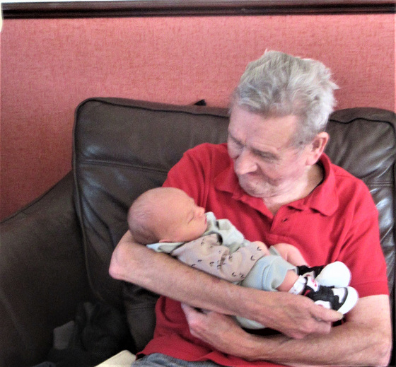 Mickey holding his second great grandchild, Noah.