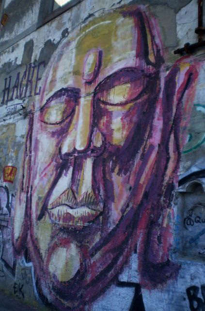 Face on wall of abandoned building.