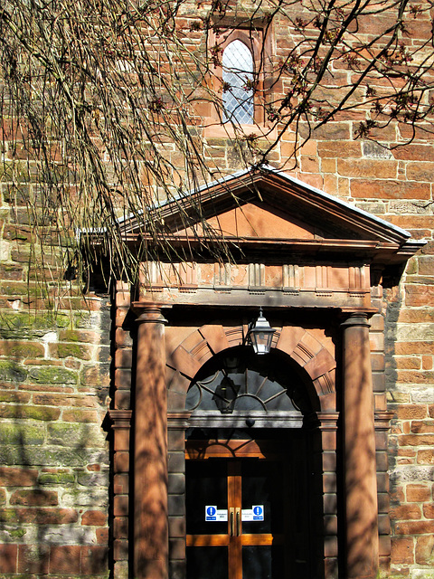 Georgian door with Doric columns on the ancient tower.