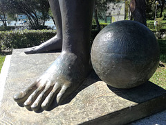 Imagine to kick the bronze ball with naked feet