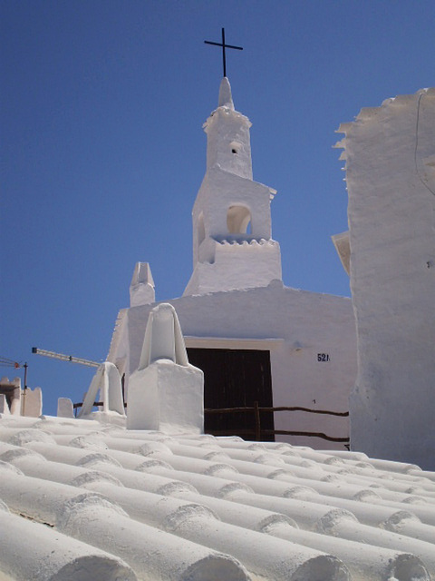 Immaculate white: church, chimneys and roofs.