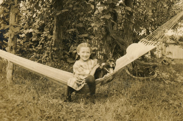 A Girl and Her Dog on a Hammock