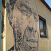 Portrait carved on wall by Vhils.