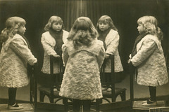 Mirror Photo of a Little Girl Standing on a Chair