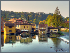 Mills reflecting on Mincio River, Borghetto