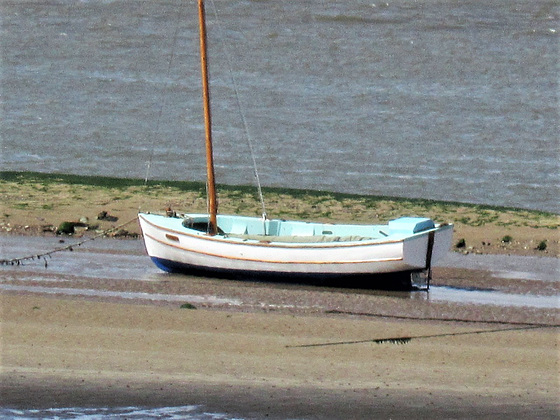 Solitary boat beached on the river bank