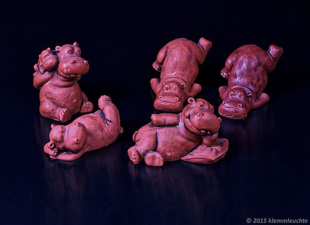 Lazy Hippos Group, colored cast ceramic, massive.