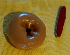 Penknife and Donut on Yellow Cloth