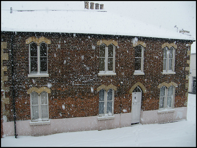English house in the snow