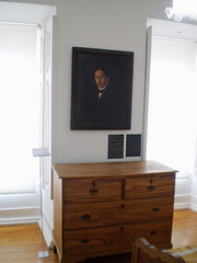 Chest of drawers and portrait of Fernando Pessoa.