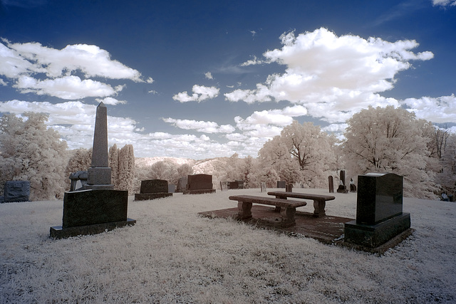 The cemetery is big but the cloud-filled sky is bigger