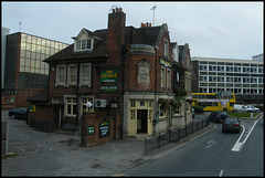 old pub surrounded by carbuncles