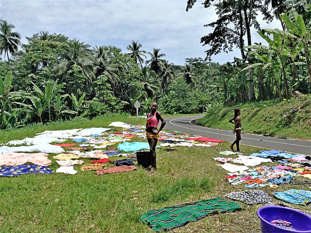 Girls  drying clothes in the grass