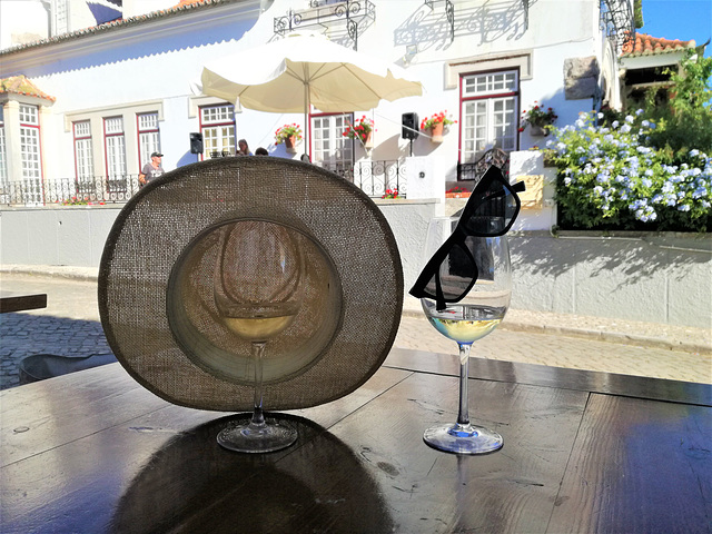 It's perfectly plausible for a glass of white wine to wear the hat and the sunglasses of the drinker