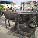 Sculpture of donkey pulled cart.