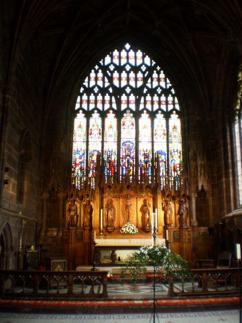 High-altar and stained glass window.