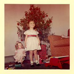 A Girl and Her Doll in Front of the Christmas Tree
