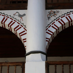 Arch detail: stork with snake