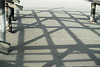 Shadows of beach chair frames on the sandbank in front of Ording