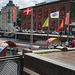 Flaggenparade im alten Hafen von Kopenhagen. Im Hintergrund Schwimmwesten von Ertrunkenen im Kunstmuseum zum Thema Einwanderung