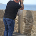 Man with telescope in St Malo