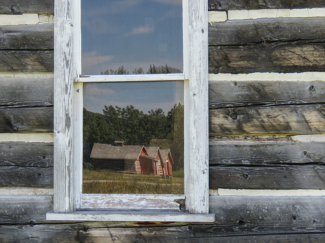 Reflections in a log cabin window