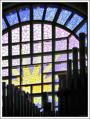 Stained glass window behind the pipe organ