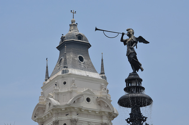 Lima, The Main Square, Bronze Figurine on the Top of the Fountain and the Top of the Bell Tower of the Cathedral
