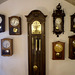 Standing clock and wall clocks.