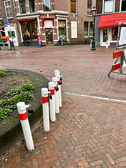 Poles waiting to be used to close the street