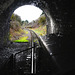Driving a railway locomotive inside the black walls of the tunnel.