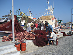 Fishermen repairing the nets (Paros/Greece)