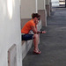 Cuban girl in high heels buzy with her cell phone